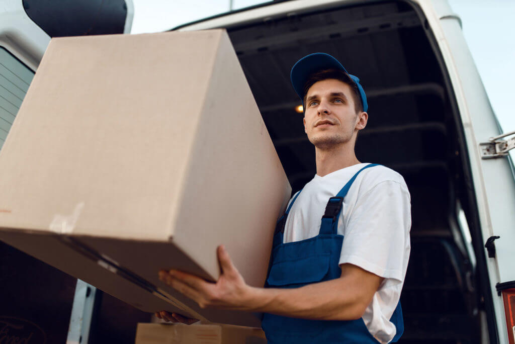 loader in uniform holding box delivery service